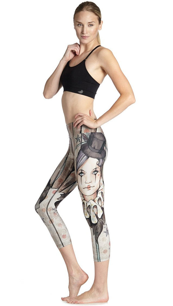 left side view of model wearing circus girl themed printed capri leggings