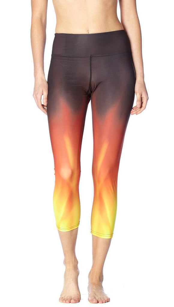 front view of model wearing fire themed printed capri leggings