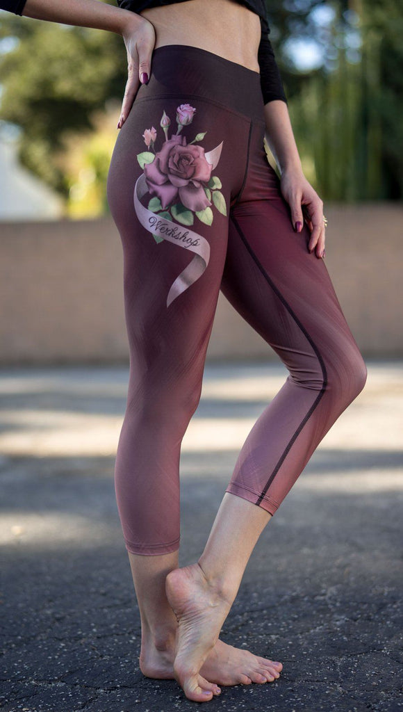 closeup right side view of model wearing tattoo rose design printed capri leggings