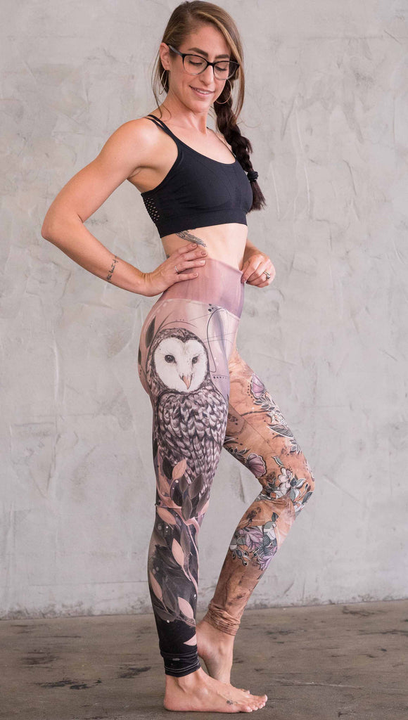 Zoomed out right view of model wearing the jackalope mashup leggings in a light mauve and brown color. This leg has a owl on it