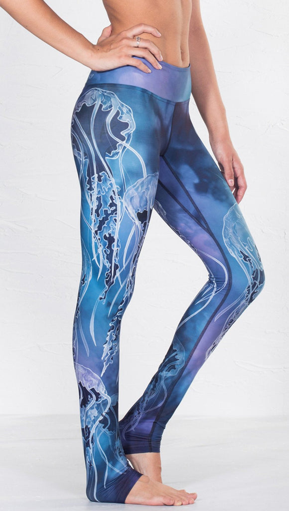 close up right side view of model wearing jellyfish themed printed full length leggings