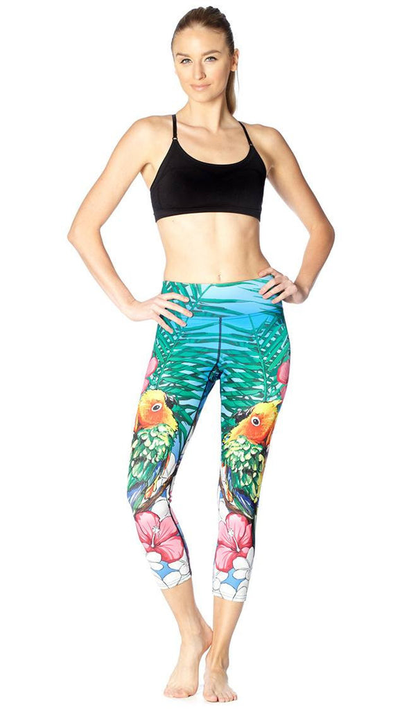 front view of model wearing lovebird themed printed capri leggings