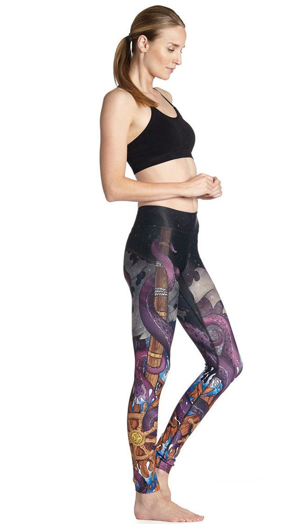 right side view of model wearing mythical octopus themed printed full length leggings