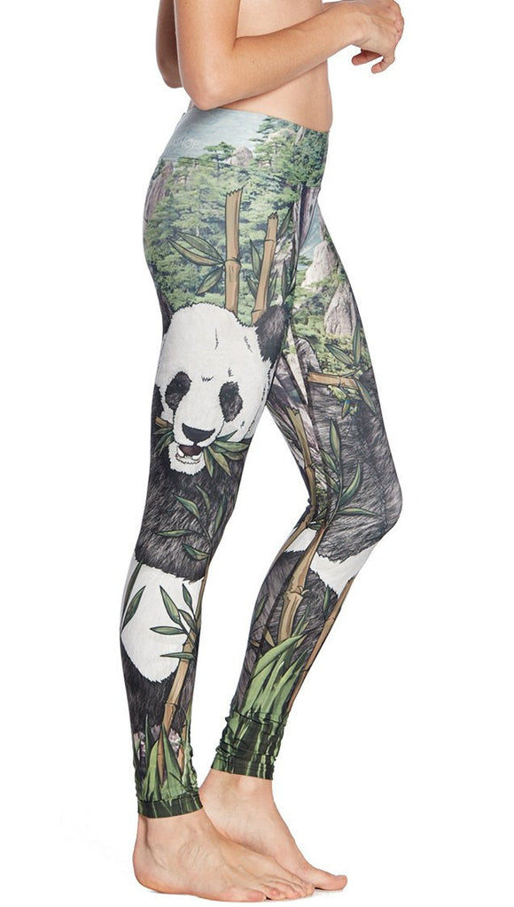 close up right side view of model wearing panda themed printed full length leggings