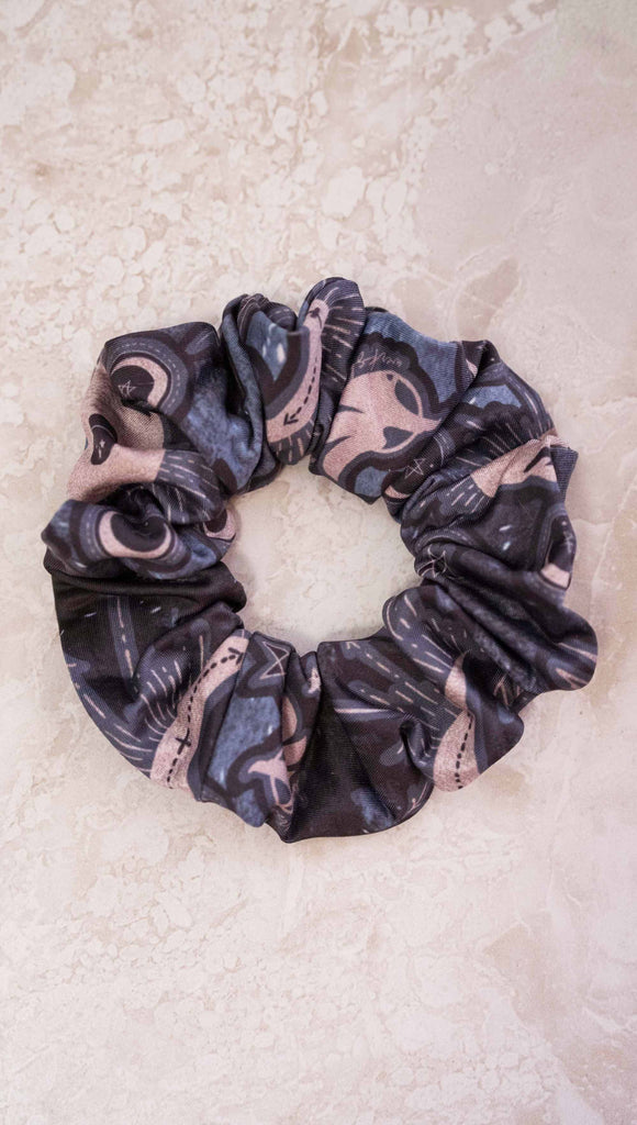 Tarot card themed printed hair scrunchie. The blue/tarot artwork has skulls, snakes, moons and the names of multiple popular tarot cards like "Strength, Lovers, Death and The Hanged Man"