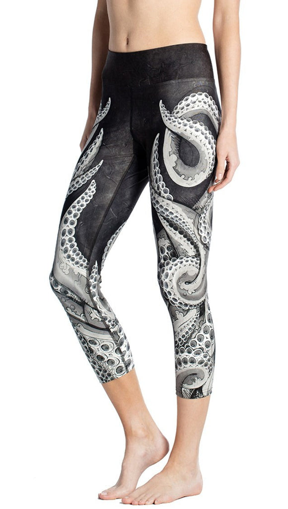 close up side view of black and white tentacle themed printed capri leggings