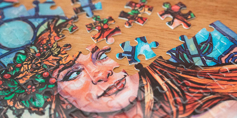 zoomed in photo of a puzzle made with Scott Sava's artwork (a portrait of a woman in front of a stained glass window)