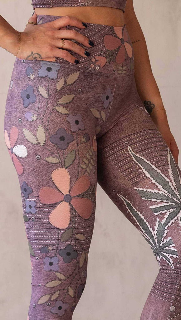 Model wearing WERKSHOP Dope + Flowers Mashup leggings. The leggings are printed with original artwork by Chriztina Marie. One leg features patchwork daisys over grainy mauve toned leather background. The other leg features marijuana leaves over a warm brown background. Both legs have faux stitching.