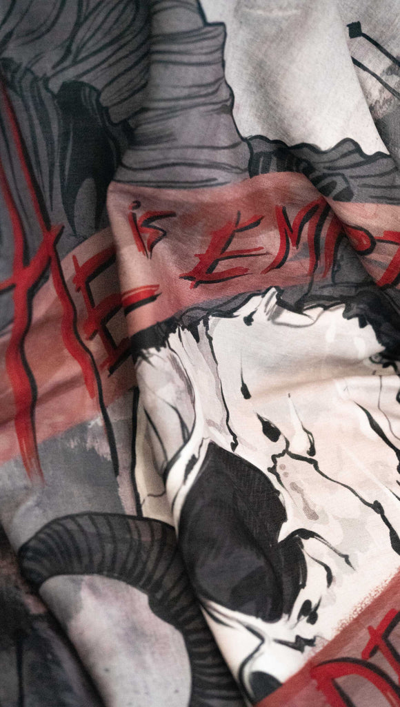 zoomed in image of a decorative blanket with a skull over a distressed background. Featuring the quote, "Hell is Empty and All The Devils Are Here" by William Shakespeare from the play, The Temptest.