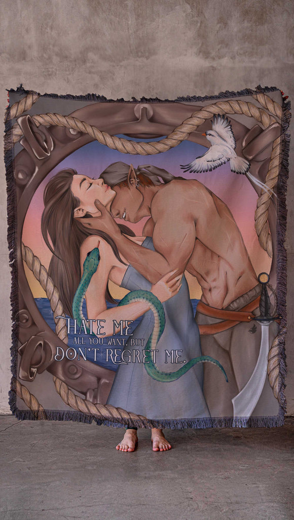 Officially Licensed WERKSHOP X The Ever King Tapestry/Blanket. "The Serpent and the Singbird" The artwork features Erik Bloodsinger passionately kissing Livia in front of a porthole window with a rope wrapping aroung it and the quote, "Hate me all you want, but don't regret me"