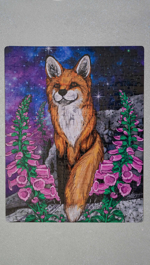 252 piece jigsaw puzzle featuring original artwork of a fox with foxglove in front of a galactic sky. A % of the proceeds benefit Save a Fox Rescue.