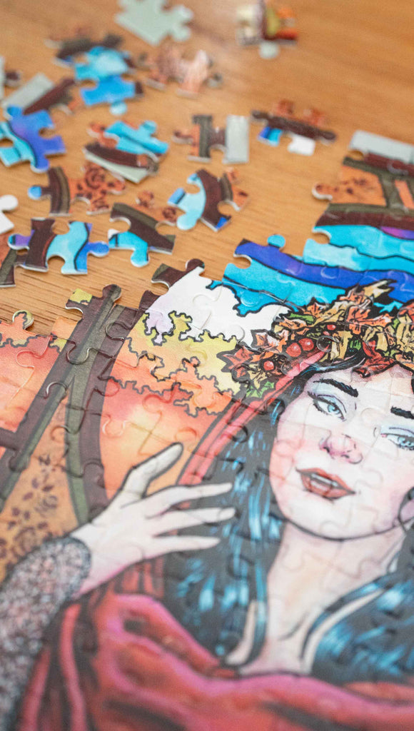 Partially disassembled Art Nouveau Puzzle featuring original artwork by Scott Christian Sava. The painting features a woman with a cloak and crown of autumn leaves standing in front of a stained glass window.