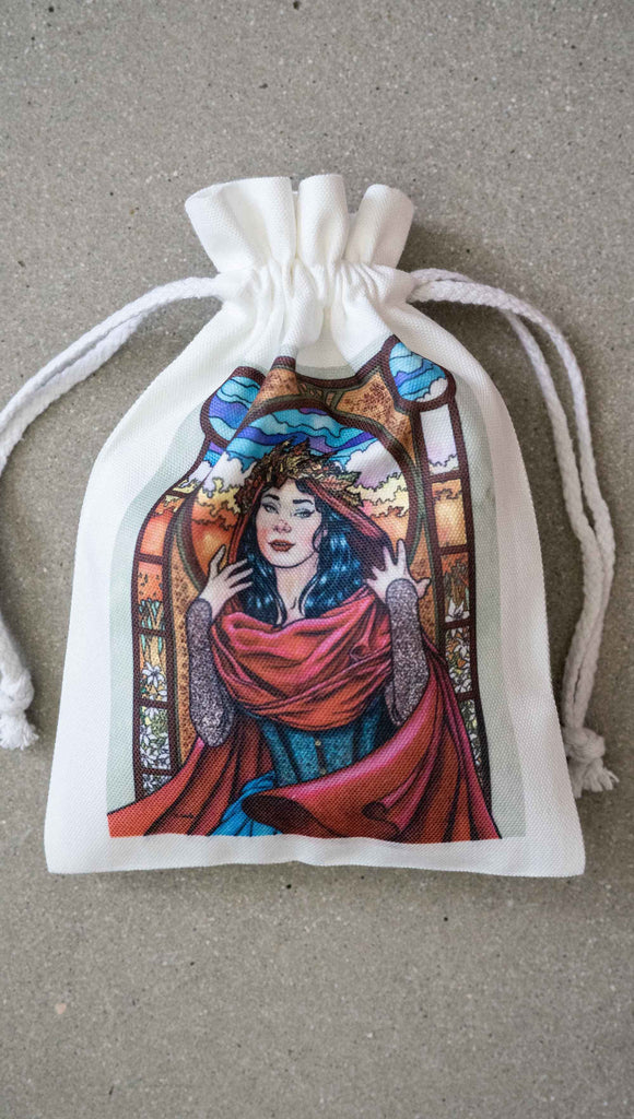 Matching drawcord pouch for Art Nouveau Puzzle featuring original artwork by Scott Christian Sava. The painting features a woman with a cloak and crown of autumn leaves standing in front of a stained glass window.