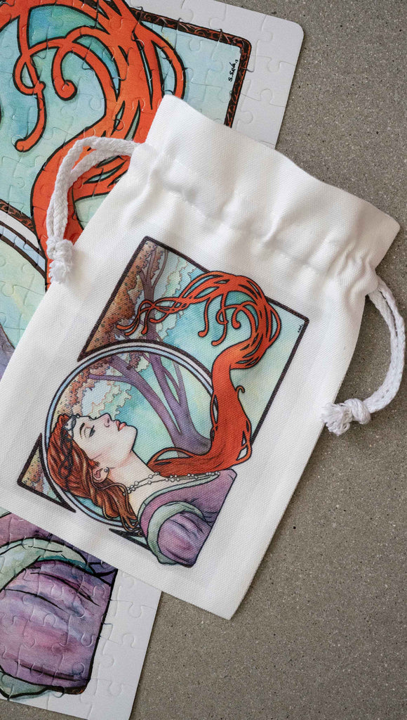Matching Art Nouveau drawcord pouch by Scott Christian Sava. The painting features a woman wearing a crown and pearls with long flowing red locks; standing in front of a round window.