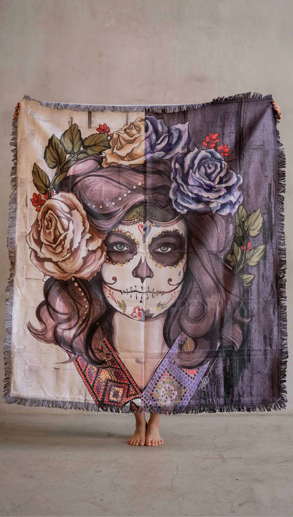 Decorative Chenille Tapestry printed with limited edition artwork by our Female Founder, Chriztina Marie. The artwork celebrates Dia De Los Muertos with a drawing of a girl wearing sugarskull makeup surrounded by a wreath of roses.