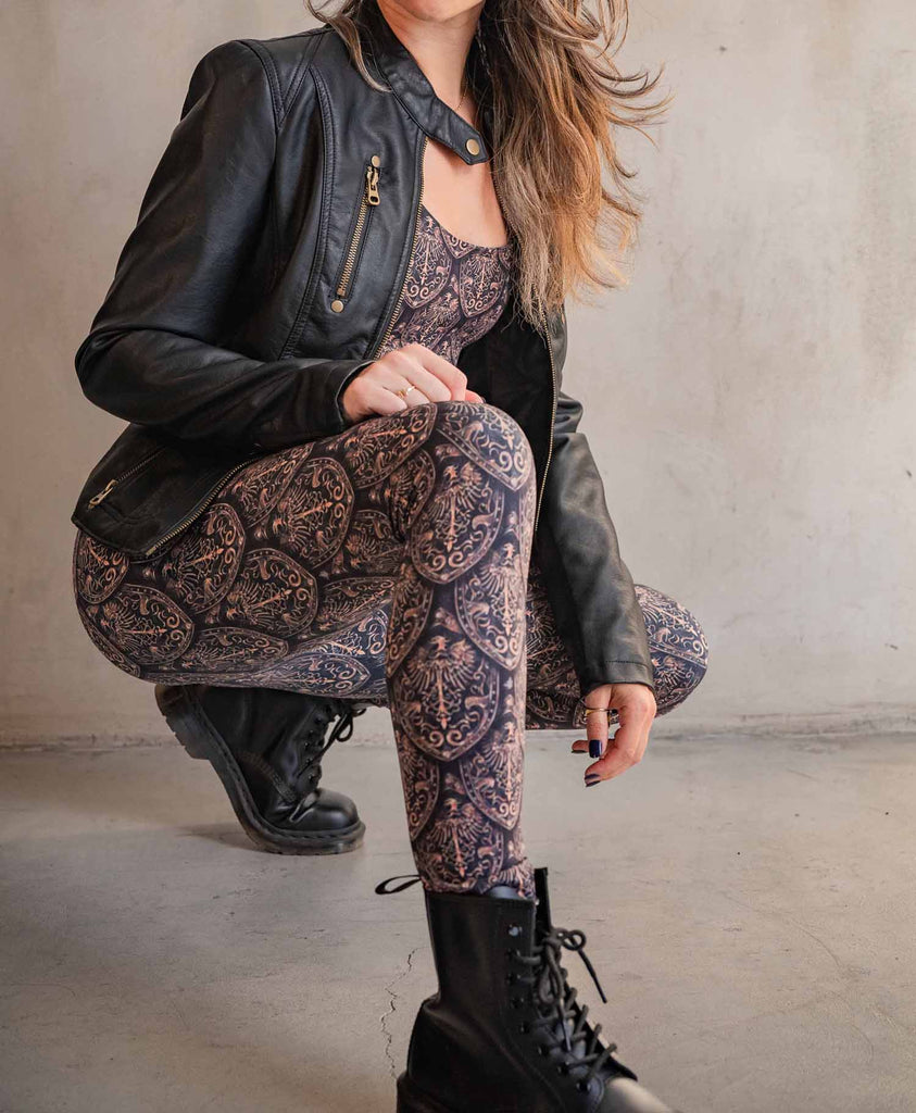 Model wearing WERKSHOP Dragon Rider (Gold) Athleisure Set paired with a leather jacket and combat boots.