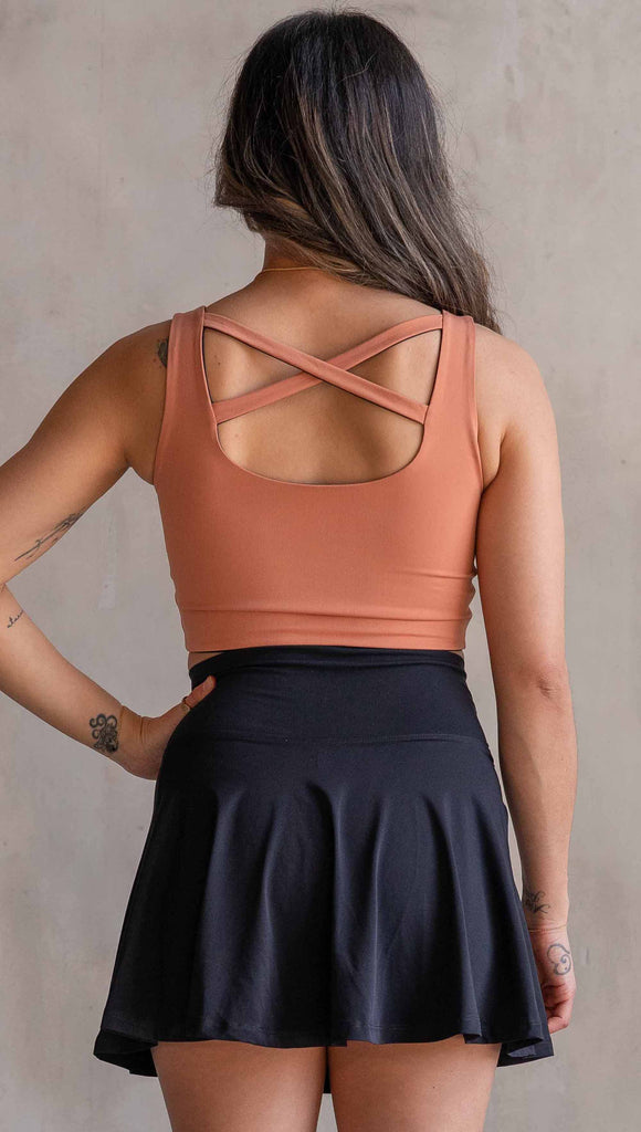 Model wearing WERKSHOP Four Way Reversible Top in EnviSoft Fabric. She is wearing the Toasted Nut side out in this photo with the “X” detail in the back.