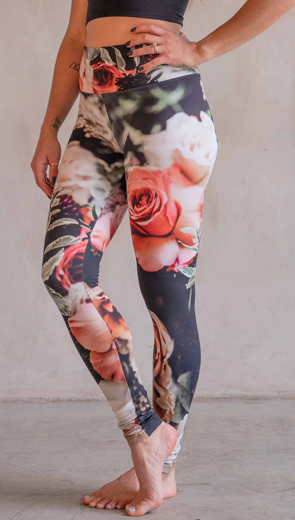 Model wearing WERKSHOP Bodacious Bouquet Athleisure Leggings. The leggings feature a floral bouquet with pink and white roses and leafy greens throughout