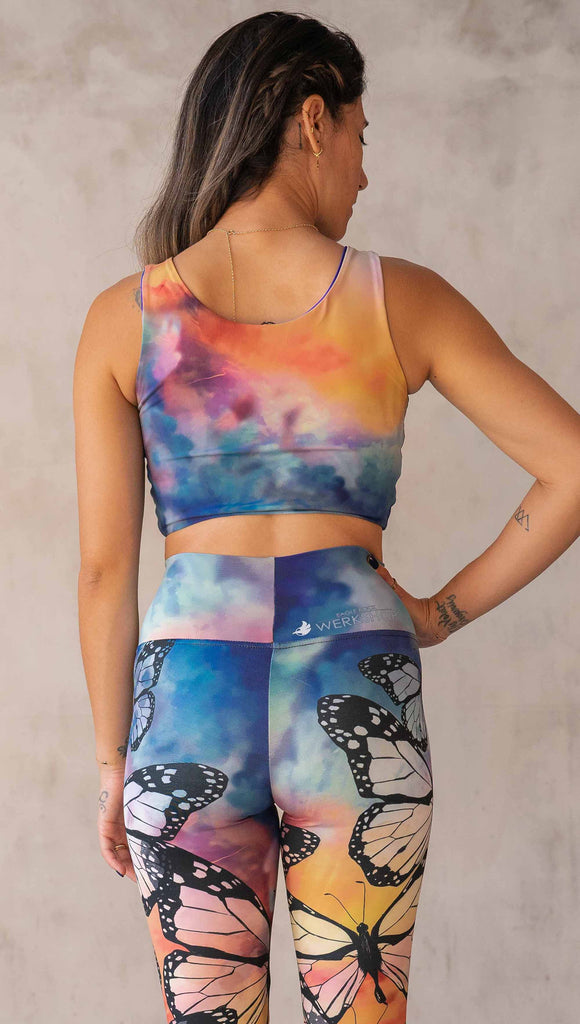Model wearing WERKSHOP Butterflies and Dragonflies Reversible top. This image shows the "butterflies" side with rainbow watercolors that match our butterflies leggings.