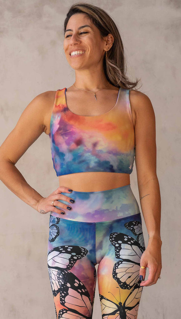 Model wearing WERKSHOP Butterflies and Dragonflies Reversible top. This image shows the "butterflies" side with rainbow watercolors that match our butterflies leggings.