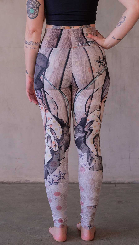 Model wearing WERKSHOP Circus Girl Leggings. Featuring artwork of a circus girl wearing a top hat, ruffled collar with mime makeup over a polka dot and woodgrain background.