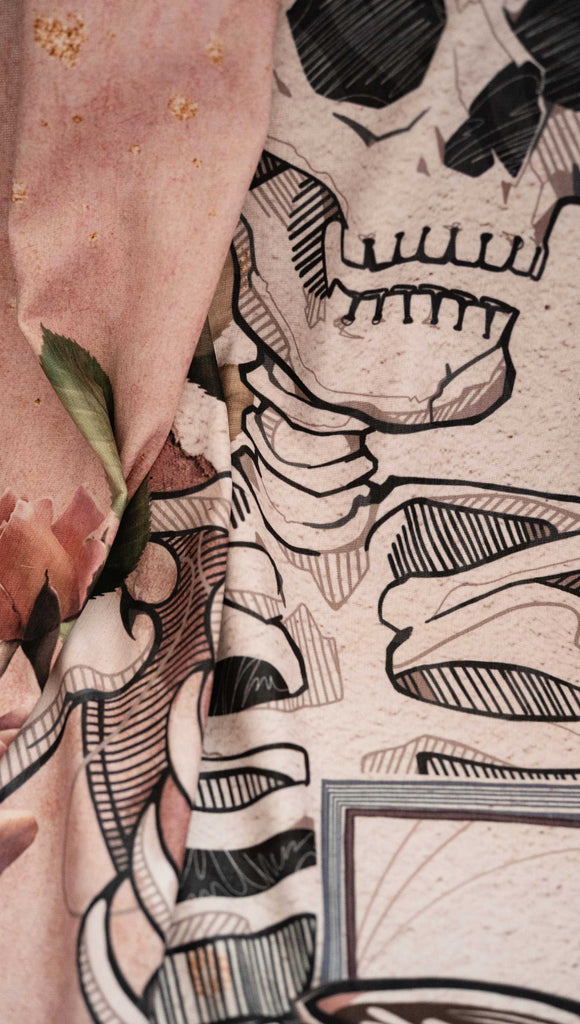 Zoomed in image of blanket with a skeleton and floral design on a textured surface. with the phrases, "Death by TBR" and "How to Find Time to Read more Books"