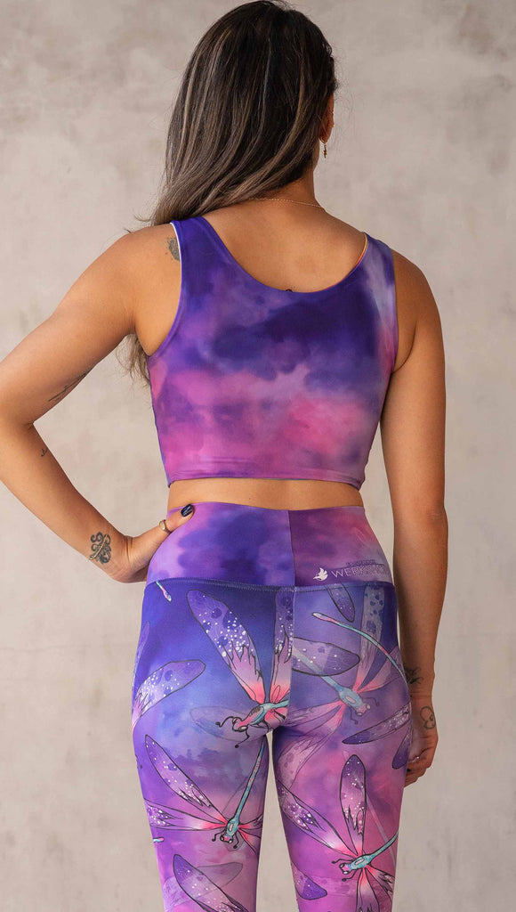 Model wearing WERKSHOP Butterflies and Dragonflies Reversible top. This image shows the "dragonflies" side with a purple and pink watercolor print. It matches our Dragonflies leggings.