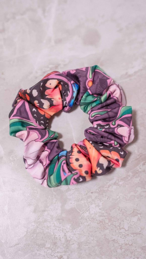 WERKSHOP Enchanted Garden Hair Scrunchie. Its mostly purple with bright pops of pink, coral, green and blue. 
