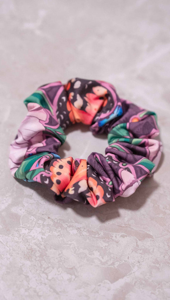 WERKSHOP Enchanted Garden Hair Scrunchie. Its mostly purple with bright pops of pink, coral, green and blue. 