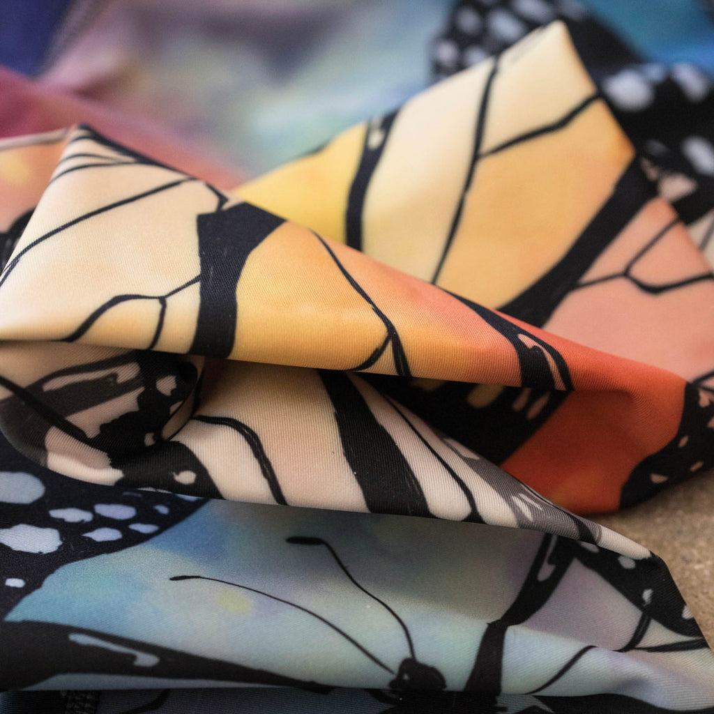 zoomed in image of our Italian triathlon fabric with butterflies print