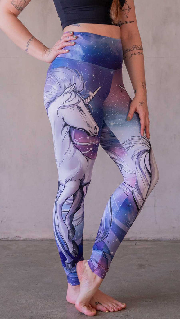 Model wearing WERKSHOP Galactic Unicorn Leggings. Featuring original and exclusive artwork of a white unicorn over a purple, pink and blue galactic background. 