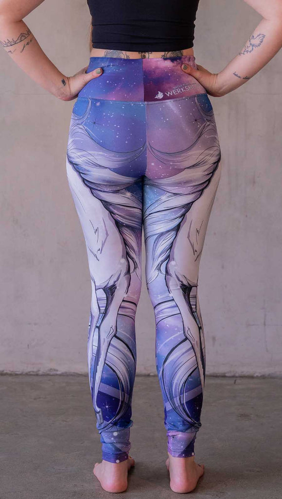 Model wearing WERKSHOP Galactic Unicorn Leggings. Featuring original and exclusive artwork of a white unicorn over a purple, pink and blue galactic background. 