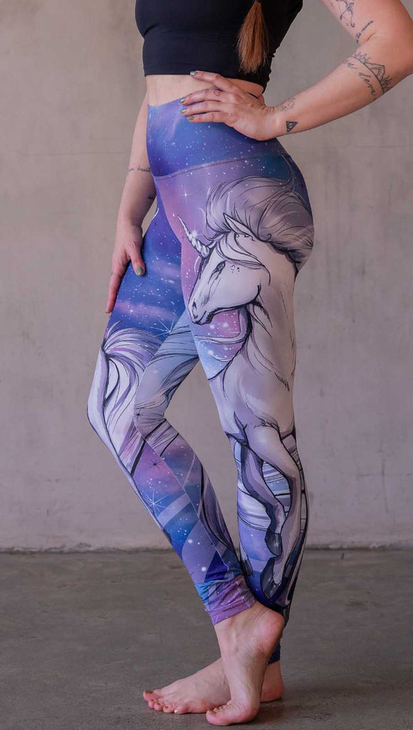 Model wearing WERKSHOP Galactic Unicorn Leggings. Featuring original and exclusive artwork of a white unicorn over a purple, pink and blue galactic background. 