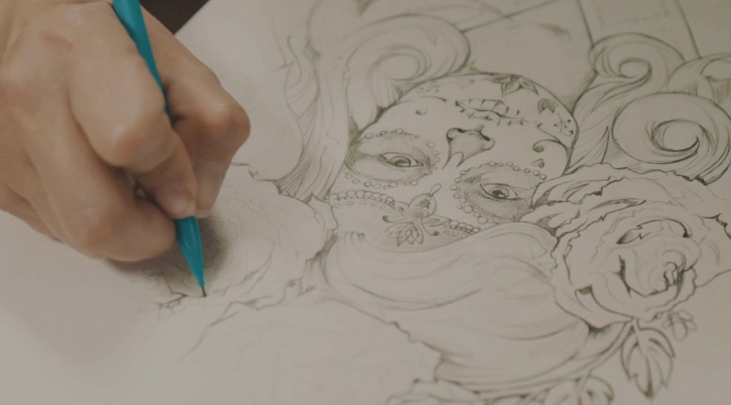 a zoomed in shot of Chrztina Marie illustrating the WERKSHOP Sugar Skull artwork on paper.