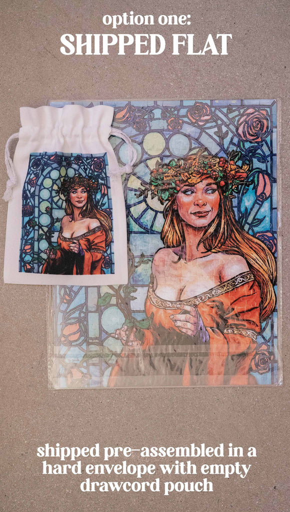Jana Rose Puzzle by Scott Christian Sava. The artwork on the puzzle features a woman with a wreath crown on her head and a bright red dress standing in front of a stained glass window. Option 1: shipped flat. Shipped pre-assembled in a hard envelope with empty drawcord pouch