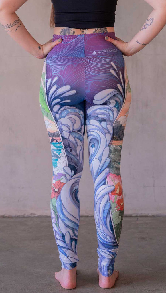 Model wearing WERKSHOP Surfboard leggings featuring Model wearing WERKSHOP Onyx leggings featuring original and exclusive polygon artwork that has a dark gray and black at the waistband to light gray ombre fade below the knee. The design is asymmetrical with the WERKSHOP eagle logo is on the wearers left hip. 