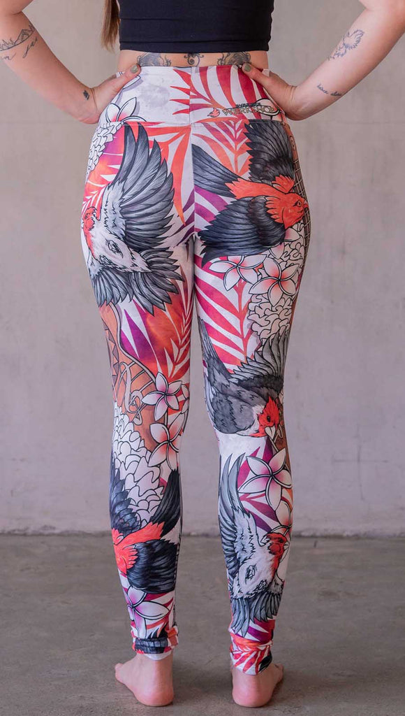 Model wearing WERKSHOP Ukulele leggings featuring original and exclusive artwork of a Ukulele and tropical birds with flower lei and bright palm fronds. 