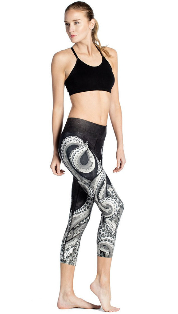 Right side view of black and white tentacle themed printed capri leggings