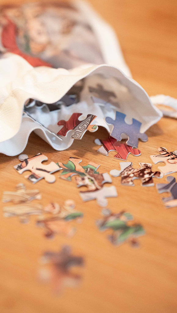 Zoomed in image of Athena puzzle pieces falling out of a matching drawcord bag.