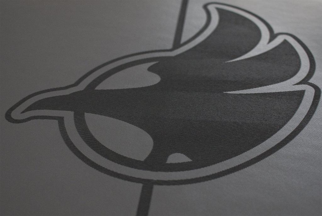 Closeup view of werkshop logo on black yoga mat 