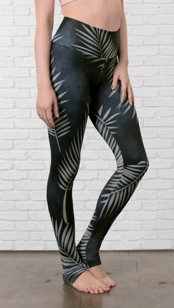 close up front view of model wearing full length black leggings with white palm design