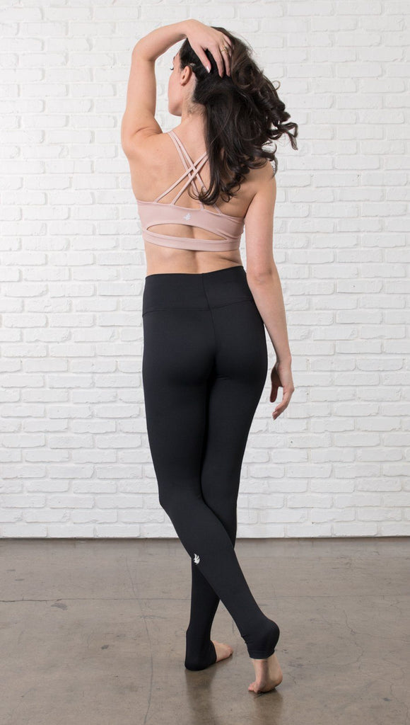 Back view of model wearing black full-length leggings