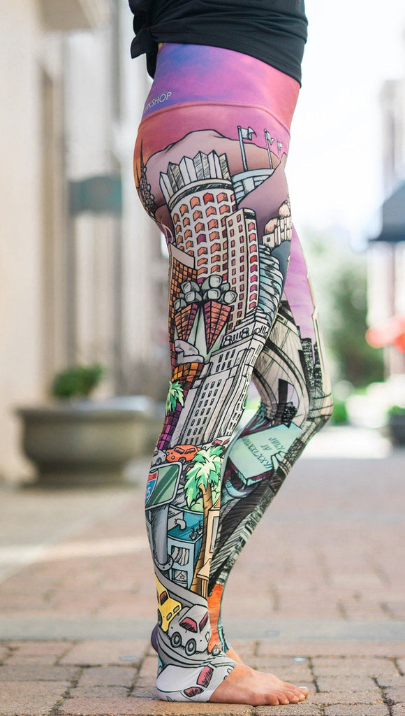 closeup right side view of model wearing full length printed leggings with various cities design