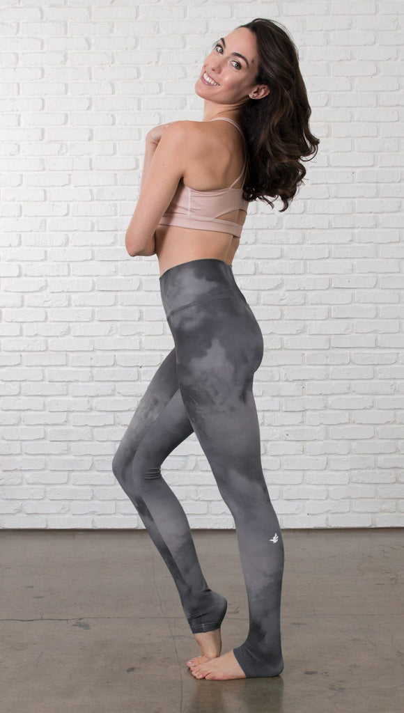 left side view of model wearing grey cloud watercolor printed full length leggings
