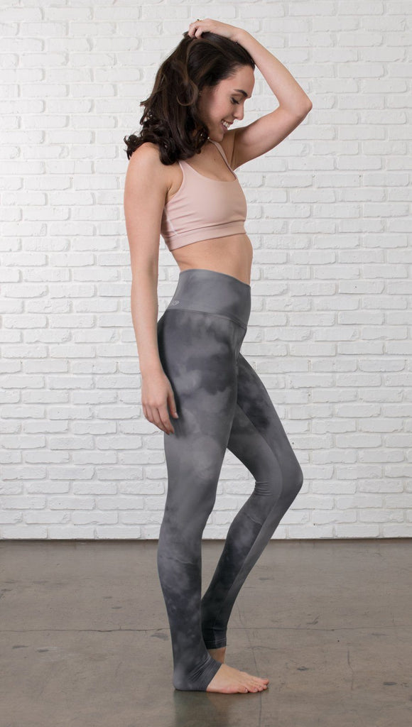 right side view of model wearing grey cloud watercolor printed full length leggings