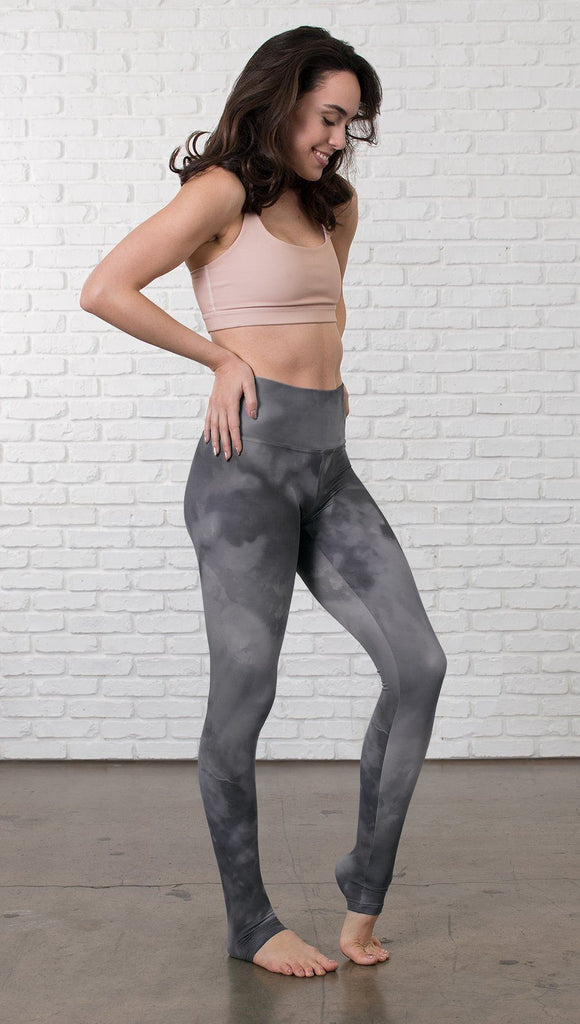 right side side view of model wearing grey cloud watercolor printed full length leggings