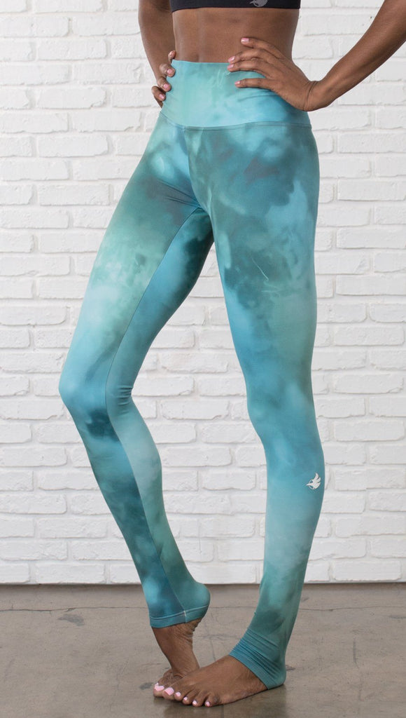closeup view of model wearing water / ocean themed printed full length leggings 