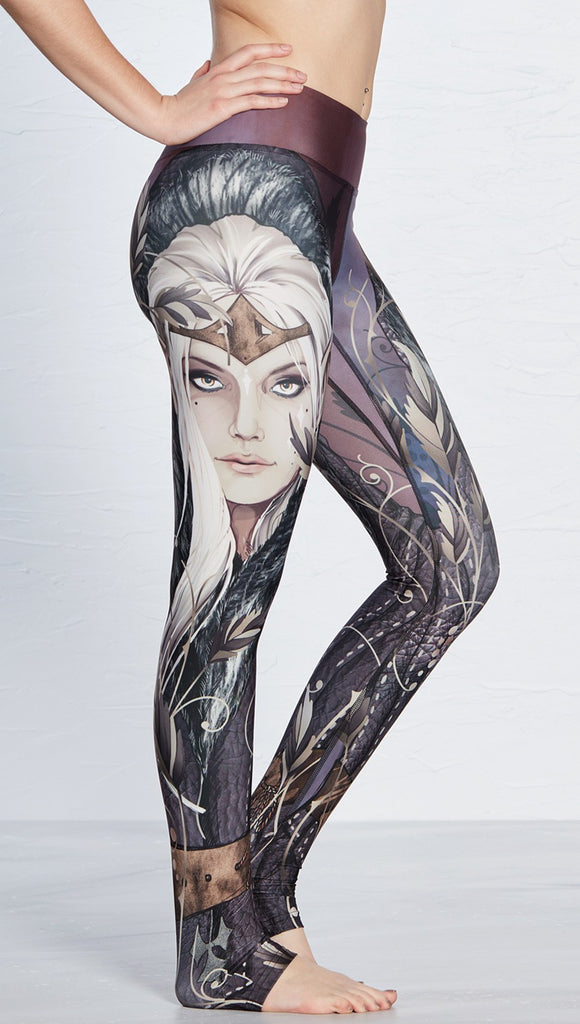 closeup right side view of model wearing full length leggings with printed elf design