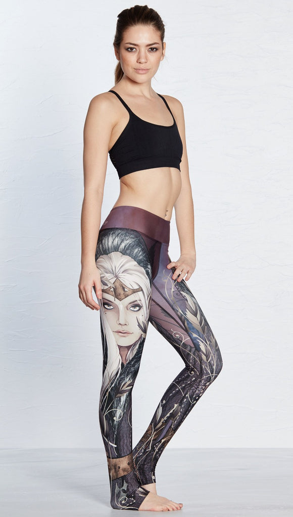 right side view of model wearing full length leggings with printed elf design
