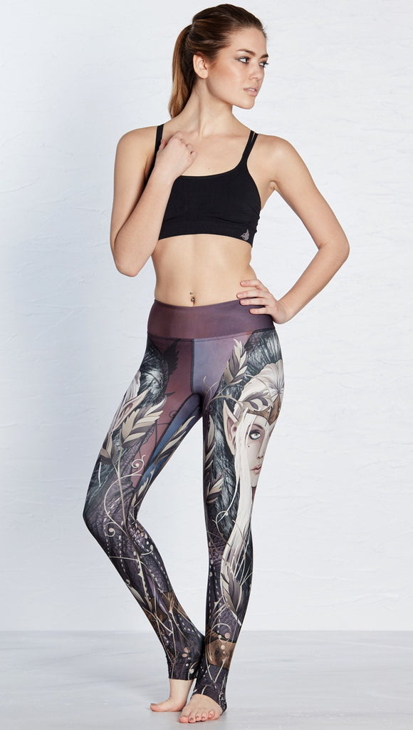 front view of model wearing full length leggings with printed elf design